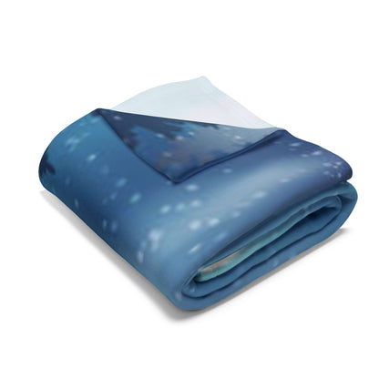 Exquisite Decorative and Warm Christmas Arctic Fleece Blanket neatly folded, highlighting its rich blue hues and soft premium polyester material.