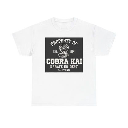 Elegant white unisex graphic t-shirt featuring the Cobra Kai logo, a striking design that embodies martial arts spirit with a vintage appeal.