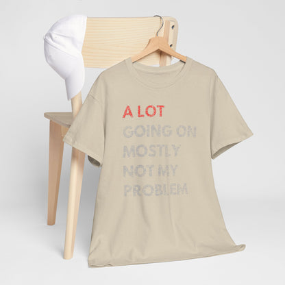 Artistic arrangement of a men's t-shirt paired with a hat, featuring the phrase 'A LOT GOING ON MOSTLY NOT MY PROBLEM' in a luxurious design, ideal for fashionable casual settings.