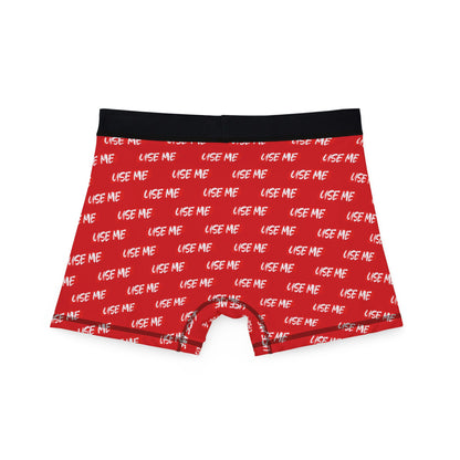 Rear view of vibrant red men's boxer briefs showcasing the humorous 'USE ME' pattern, perfect for adding a playful touch to intimate moments.