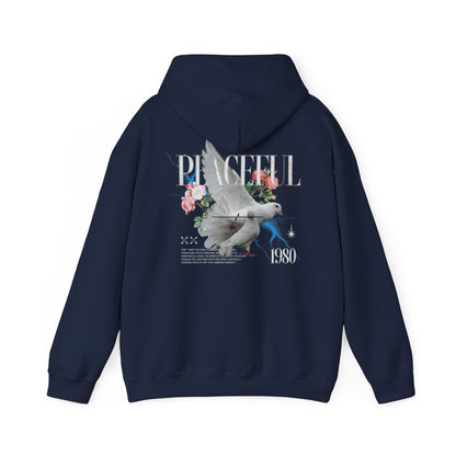 Chic navy hoodie with an artistic depiction of a dove and floral graphics, emphasising the word 'PEACEFUL' and the year '1980', designed for a luxurious appeal.