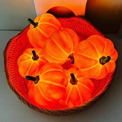 Glamorous Pumpkin Halloween Decorative Night Light arranged in a wicker basket, radiating a warm orange glow ideal for Halloween ambiance.