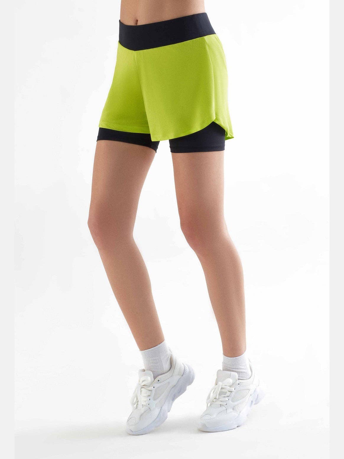 Elegant double-layer cycling shorts for women, highlighting soft stretchy fabric crafted from recycled materials, designed for a fashionable cycling experience.