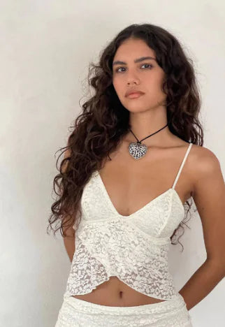 Elegant women's vintage floral lace see-through top in white, featuring delicate straps and intricate lace detailing, styled for a chic and sophisticated look.