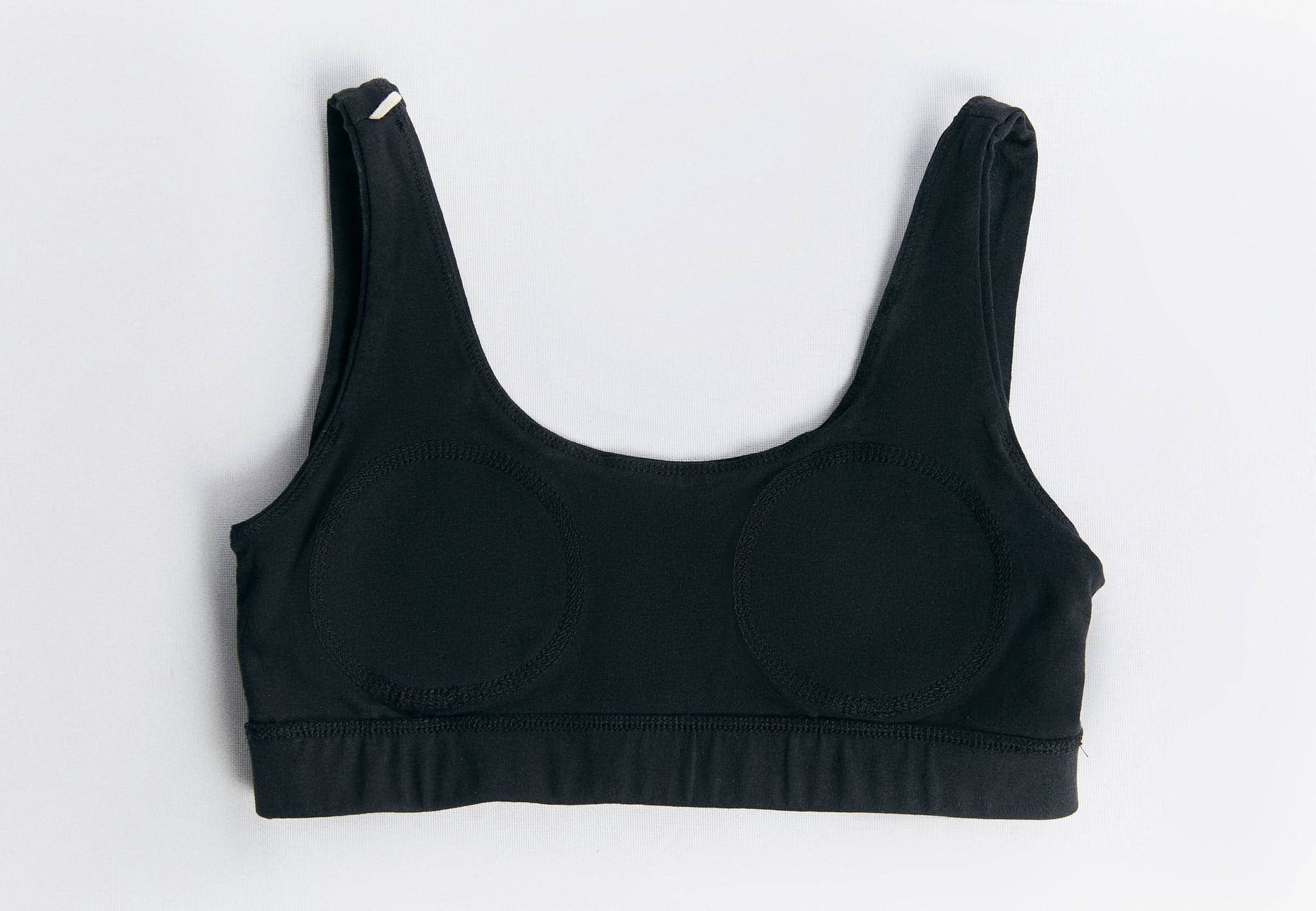 Elegant bralette with broad straps crafted from organic cotton, representing sustainable luxury for all-day wear.