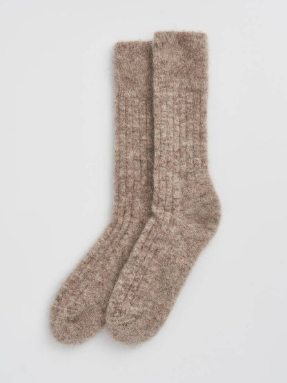 Fashionable, cushioned alpaca bed socks with a focus on the plush texture, ideal for a sophisticated lounging experience.