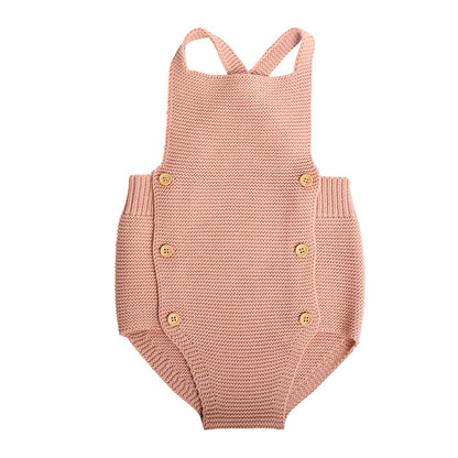 Stylish Baby Girl Cotton Romper in soft pink, featuring stylish cross-back straps and elegant button accents, perfect for all-season comfort.