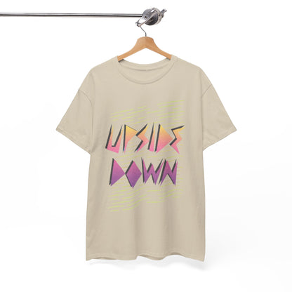 Chic beige t-shirt with a striking 'UPSIDE DOWN' graphic, elegantly displayed on a wooden hanger, embodying contemporary style.