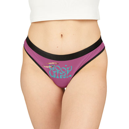 Luxurious 'Good Girl' thong panties showcased on a model, featuring a bold design with flowing lettering and elegant black trim.