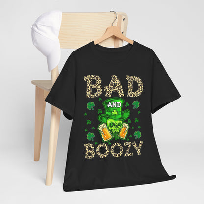 Bad And Boozy St. Patrick's Day T-Shirt displayed on a stylish wooden chair, featuring vibrant leprechaun hat and leopard print design, perfect for festive celebrations.