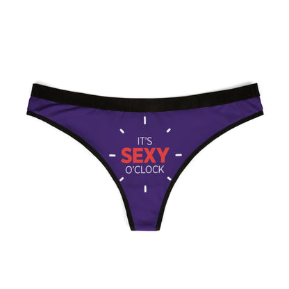 Stylish women's thong showcasing a vibrant 'IT'S SEXY O'CLOCK' print on a luxurious purple fabric, designed for those who appreciate cheeky elegance in their intimate apparel.