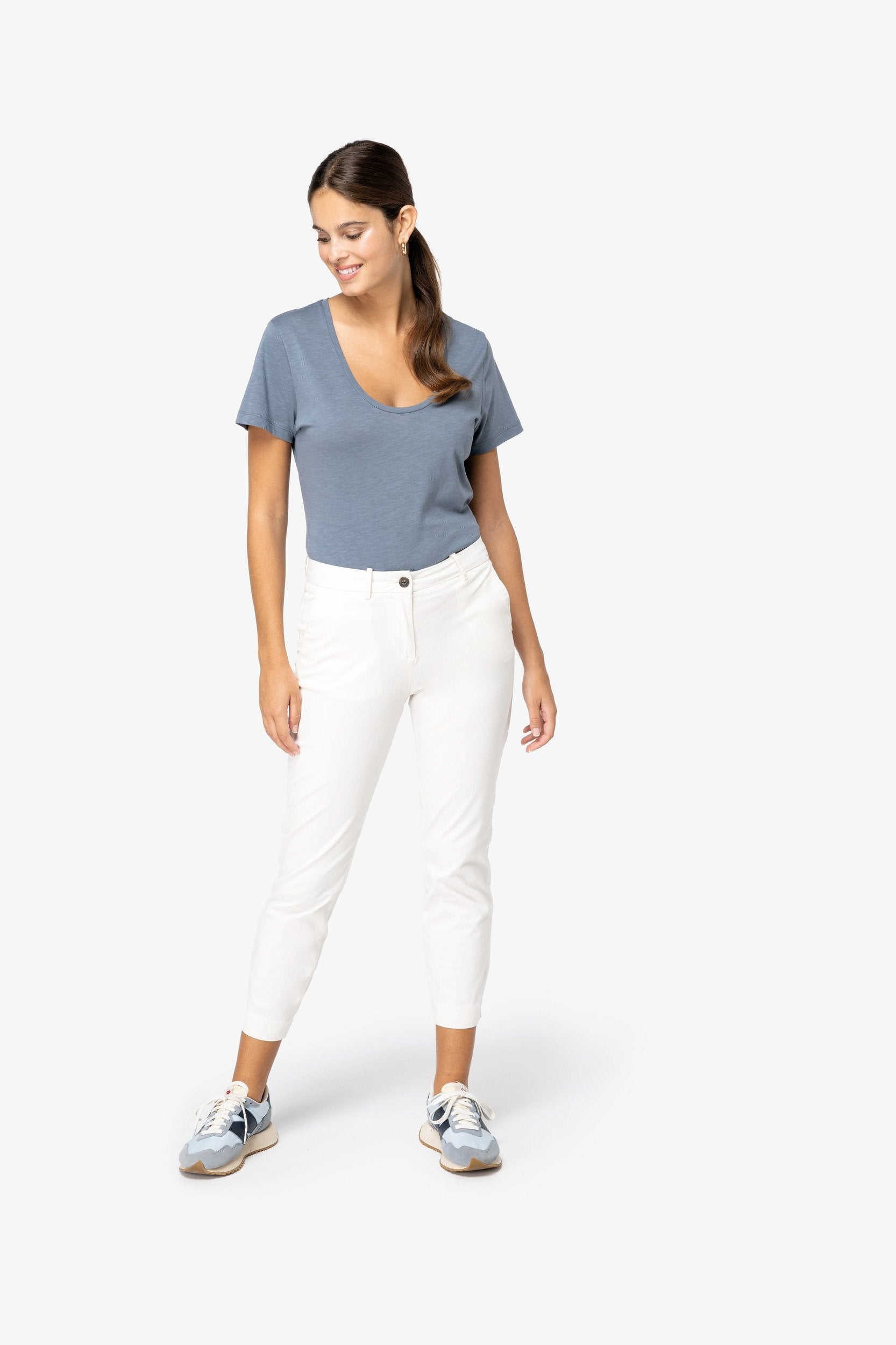 Elegant styling of minimalist straight fit chino trousers, demonstrating a sophisticated look for modern women.