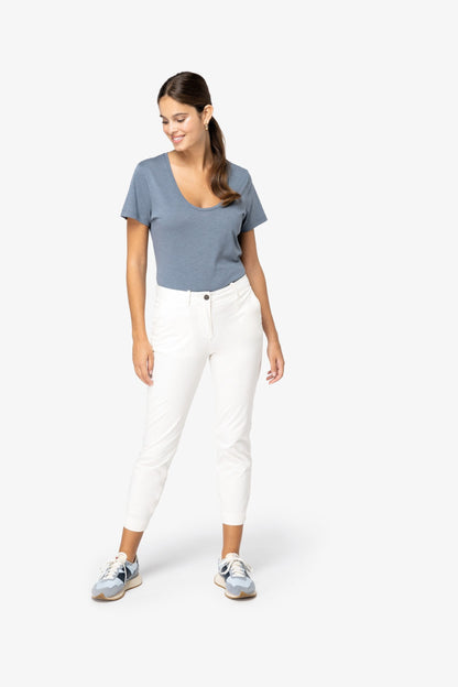 Elegant styling of minimalist straight fit chino trousers, demonstrating a sophisticated look for modern women.