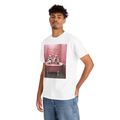 A stylish man wearing a white t-shirt featuring a whimsical design of Stormtroopers relaxing in a pink bathtub surrounded by bubbles, set against a vibrant pink tiled bathroom backdrop.