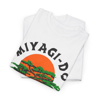 Luxuriously soft folded Miyagi-Do Karate t-shirts displaying a vibrant bonsai tree and orange sun, crafted for comfort and style in martial arts apparel.