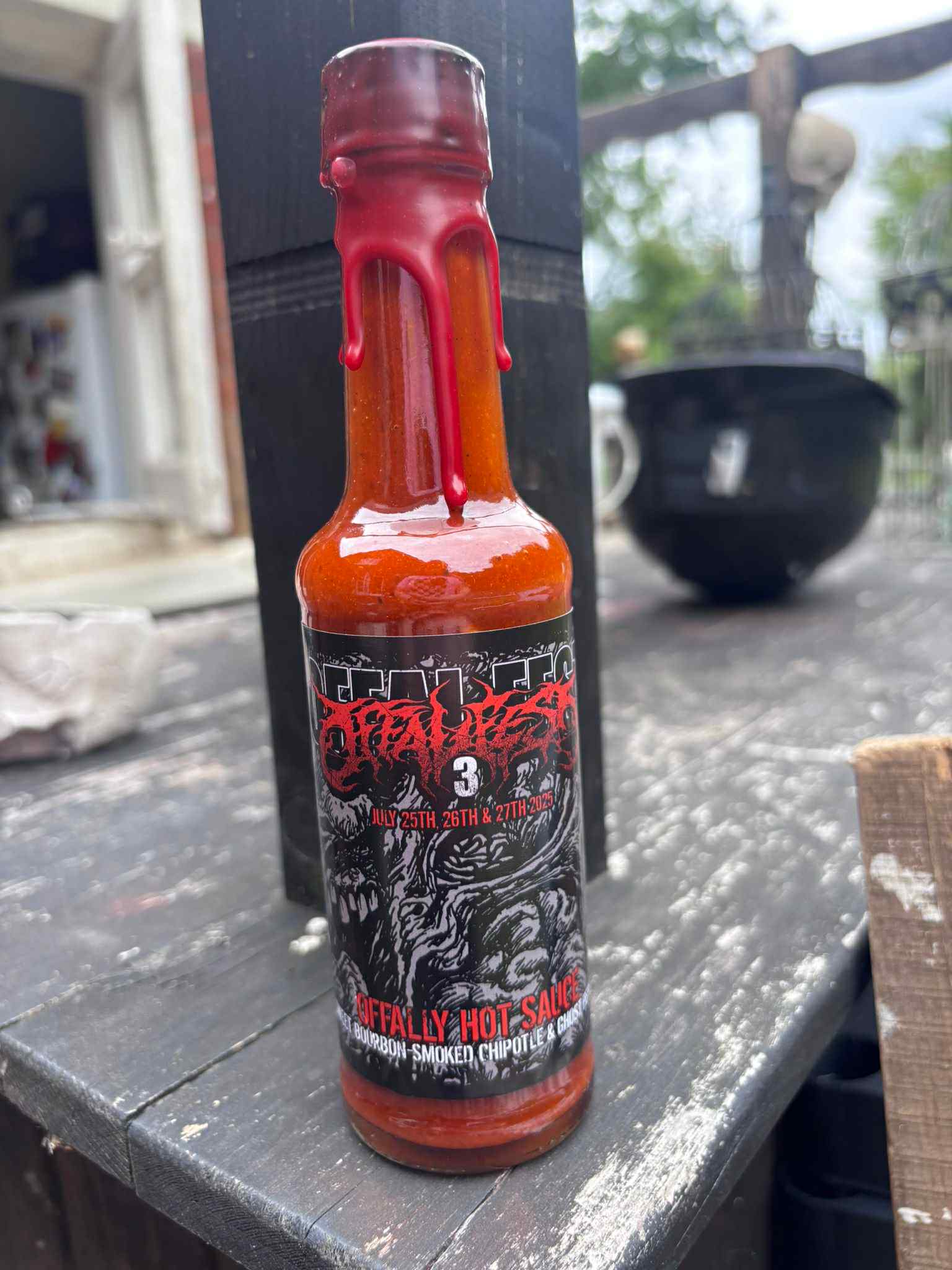 Luxurious bottle of Offaly Hot Sauce from Rancid Offal Records, featuring a unique blend of Sweet Bourbon-Smoked Chipotle and Ghost Pepper, elegantly sealed in wax for an exclusive touch.