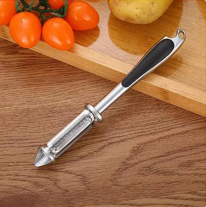 Contemporary multi-functional vegetable and fruit peeler resting on a wooden cutting board, with vibrant tomatoes and a potato, exemplifying its versatility in culinary tasks.