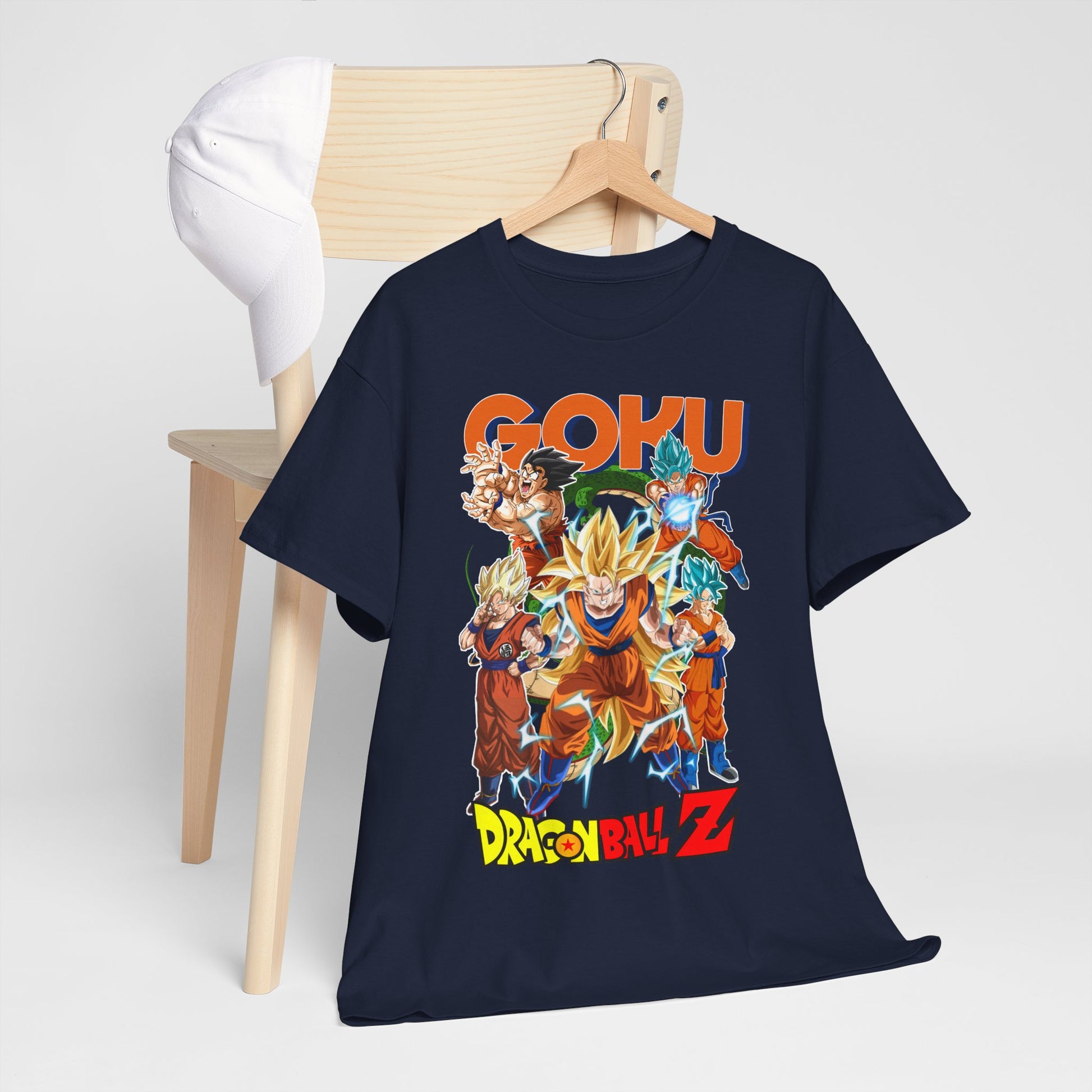 GOKU Power Surge T-Shirt artfully presented on a wooden chair next to a white cap, highlighting a captivating Dragon Ball Z design that embodies the anime's powerful aesthetic.