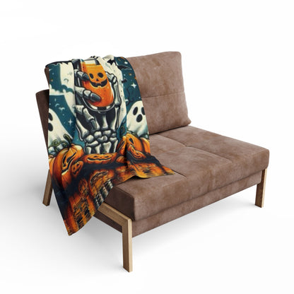 Decorative and Warm Halloween Spooky Arctic Fleece Blanket draped across a chic sofa, illustrating a playful Halloween theme with a skeleton hand and pumpkins, perfect for seasonal decor.