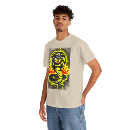 Stylish male model showcasing a unisex Cobra Kai T-shirt in a light beige shade, featuring a striking Cobra Kai logo design in vibrant colours, perfect for martial arts enthusiasts and fans of witty nostalgia.