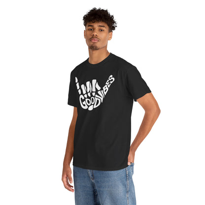Stylish black men's T-shirt adorned with a white skeletal hand graphic and the phrase 'GOOD VIBES', modelled by a confident young man in casual denim, perfect for a smart-casual outfit.