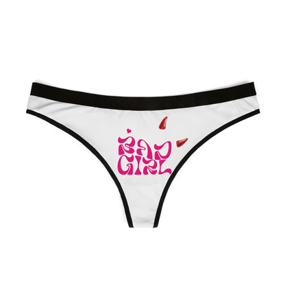 Sophisticated view of Bad Girl thong panties, showcasing the striking hot pink lettering and playful devilish accents on a pristine white fabric, complemented by a chic black waistband.