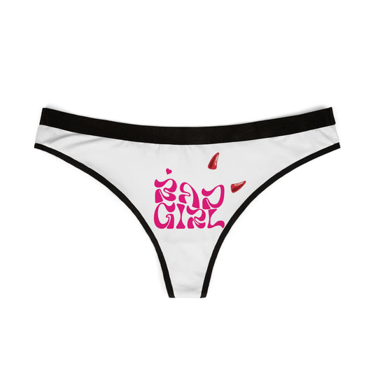 Sophisticated view of Bad Girl thong panties, showcasing the striking hot pink lettering and playful devilish accents on a pristine white fabric, complemented by a chic black waistband.