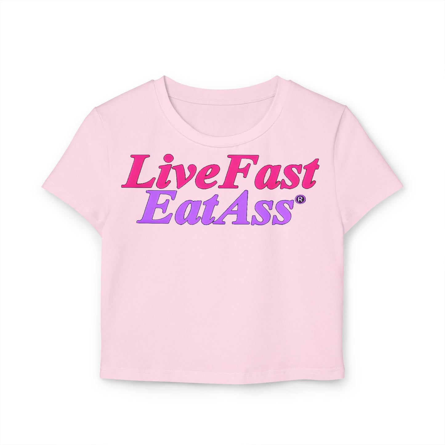 Stylish cropped t-shirt in soft pink showcasing the bold message 'Live Fast Eat Ass' in a striking gradient of pink and purple, perfect for a trendy wardrobe.