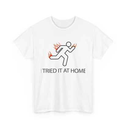 Classic white mens t-shirt featuring a minimalist stick figure and flames graphic on the front, boldly stating 'I TRIED IT AT HOME' to inspire personal journeys.