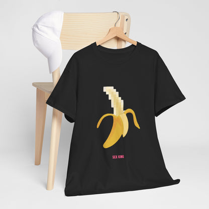 Luxurious Pixelated Banana graphic t-shirt elegantly displayed on a wooden chair with a stylish white cap, showcasing a whimsical design that combines playful artistry with contemporary fashion.