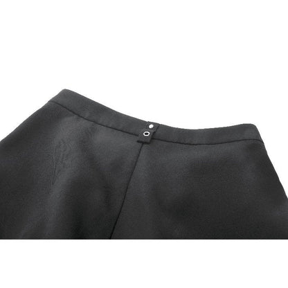 Model wearing Dark In Love High-Waisted Convertible trousers styled with chunky boots for a bold gothic look, displaying the high-rise fit.