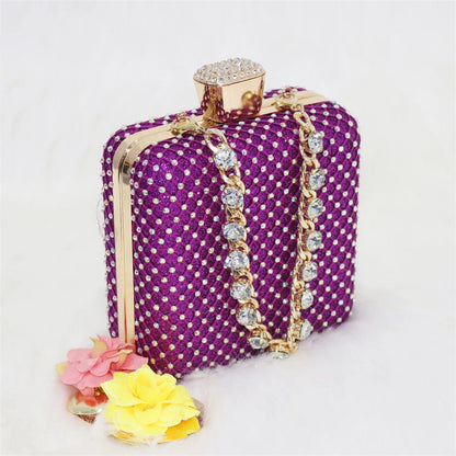 Elegant matching purple bag with metal handle and long chain shoulder strap, designed to complement purple Italian sandals.