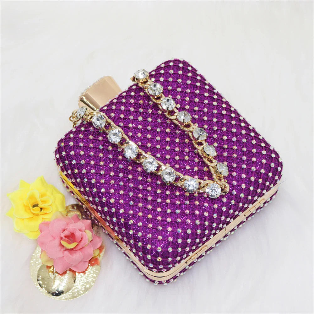 Chic purple handbag with a metallic handle, matching the luxury women's sandals, ideal for elegant occasions.