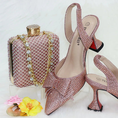 Elegant matching purple bag with metal handle and long chain shoulder strap, designed to complement luxury Italian sandals.