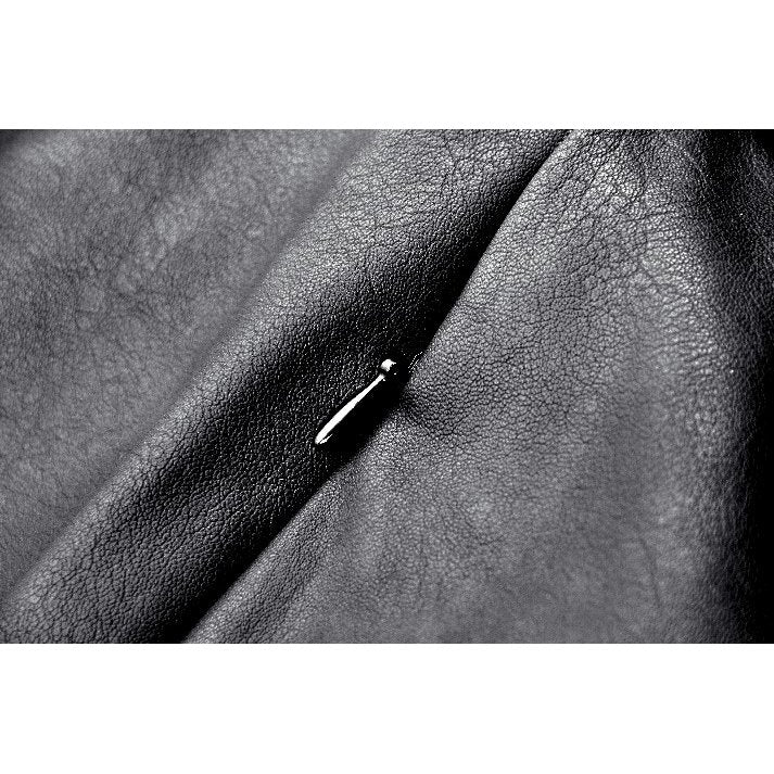 Side view of the chic faux leather mini skirt, highlighting the diagonal front flap and punk-inspired design elements.