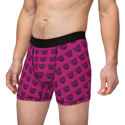 Man wearing Valentine's Naughty Cheeky Men's Boxer Briefs in vibrant pink, displaying a quirky slogan, blending comfort and style for a romantic yet playful statement.