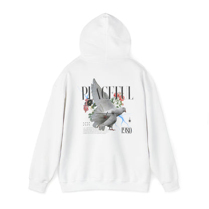 Stylish white hoodie featuring a serene dove print with floral accents and the word 'PEACEFUL 1980'. Perfect for a luxurious and artistic wardrobe.