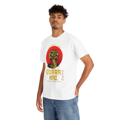 Luxurious Cobra Kai graphic t-shirt in white, showcasing a bold snake emblem, worn by a stylish young man with curly hair, set against a minimalist background.