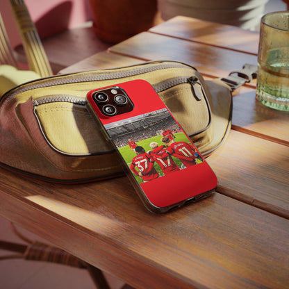 Stylish Manchester United Mainoo Garnach Hojlund Soft Phone Case resting on a vintage bag, ideal for showcasing team pride.
