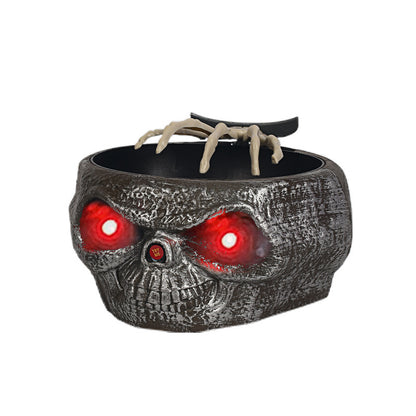 Halloween Candy Bowl With Motion Activated Skeleton Hand designed with a detailed skull appearance, illuminated with glowing red eyes for a dramatic Halloween look.