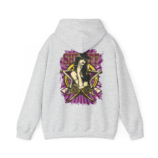 Sophisticated grey hoodie with a bold back print showcasing a powerful female sheriff illustration, featuring crossed revolvers and dramatic purple and gold elements.