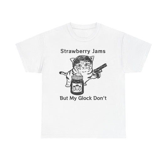 Luxurious white graphic t-shirt featuring a playful cat illustration holding a jar of strawberry jam and a handgun, with the catchy phrase 'Strawberry Jams But My Glock Don't' elegantly printed.
