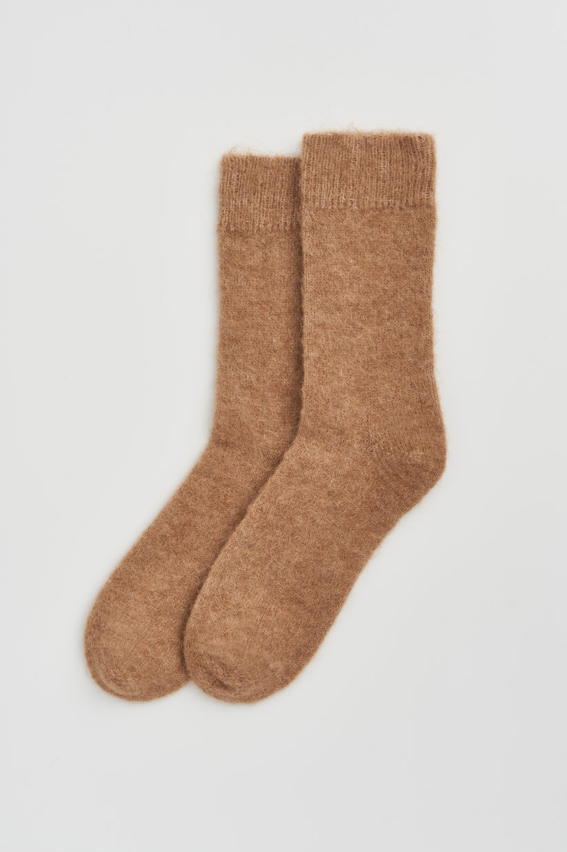 Fashionable alpaca bed socks in soothing colours, perfect for keeping feet warm in stylish comfort during chilly nights.