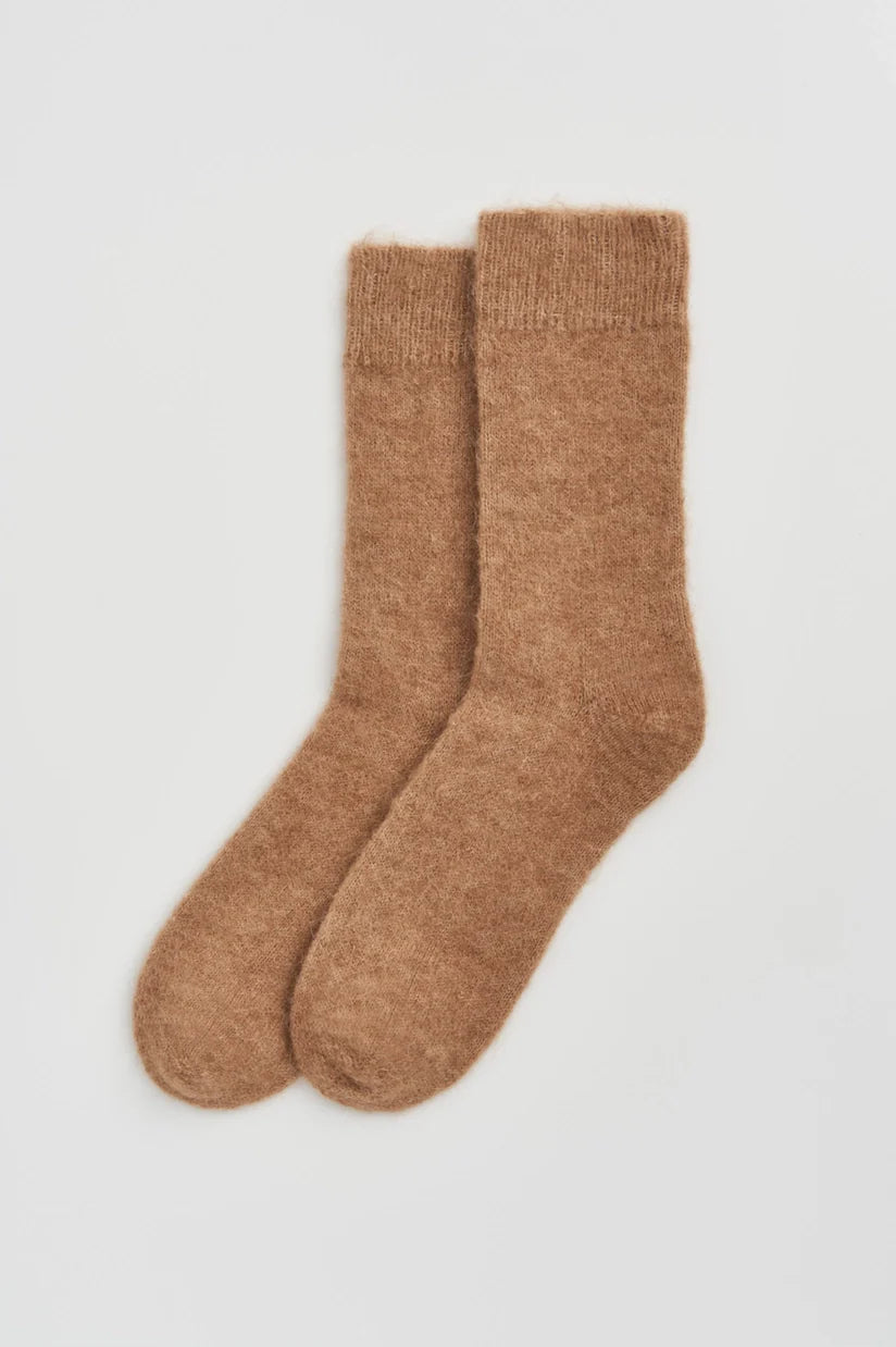 Luxurious ultra soft alpaca bed socks in a cozy setting, showcasing plush comfort and warmth for ultimate relaxation.