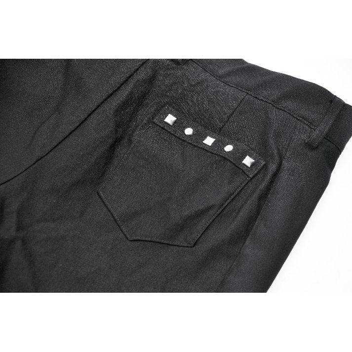 Model wearing high-waisted black garter shorts styled with fishnet tights and platform boots, perfect for a goth-punk ensemble.