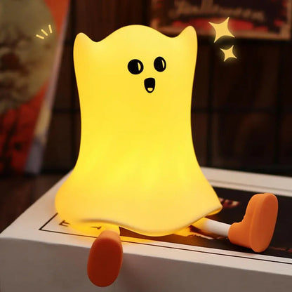 Halloween Silicone Ghost Shaped Bedside Lamp with Touch Control, emitting a soft yellow glow, providing a whimsical and luxurious touch to children's room decor.
