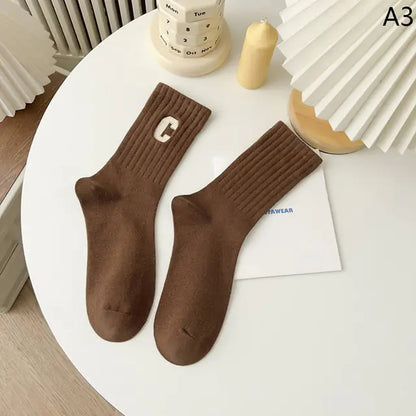 Luxurious Women's Tie-Dye Middle Tube Socks in a rich brown tone, elegantly presented with a ribbed texture, offering a stylish and comfortable accessory for all-day wear.