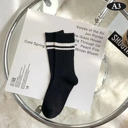 Chic Women's Tie-Dye Middle Tube Socks showcasing a refined black design with classic white stripes at the top, embodying luxurious comfort and effortless style.