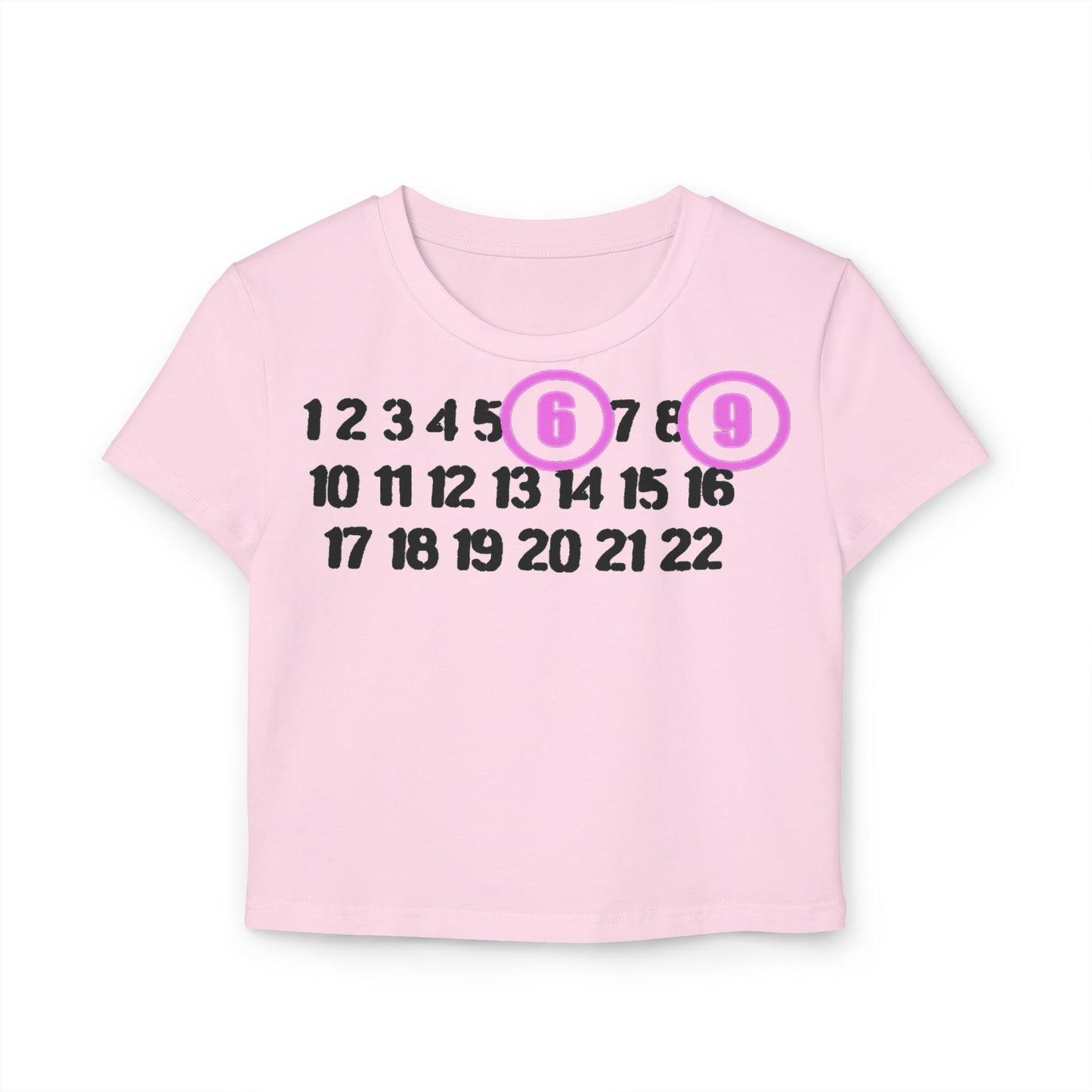 Stylish pastel pink cropped t-shirt with a unique print of numbers 1 to 22, featuring 6 and 9 outlined in light purple circles, designed in eco-friendly organic cotton.