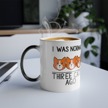 Transforming 'I Was Normal 3 Cats Ago' colour morphing mug, showing playful cat graphics, with steam rising from a warm beverage, ideal gift for cat lovers.